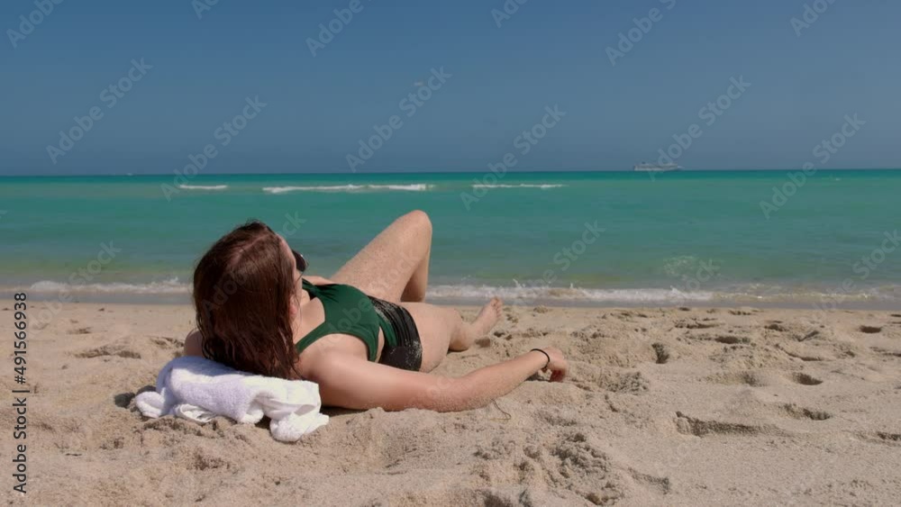 Young happy woman relaxing at Miami Beach on a sunny day - travel photography Young happy woman relaxing at Miami Beach on a sunny day - travel photography