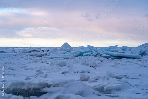 Blue Ice Chunks on Lake Michigan - Frozen Lake with snow, beautiful colorful sky, and clouds in the background