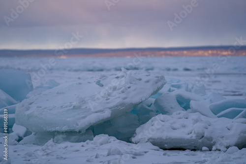 Blue Ice Chunks on Lake Michigan - Frozen Lake with Sunset, clouds, and mountains in the background