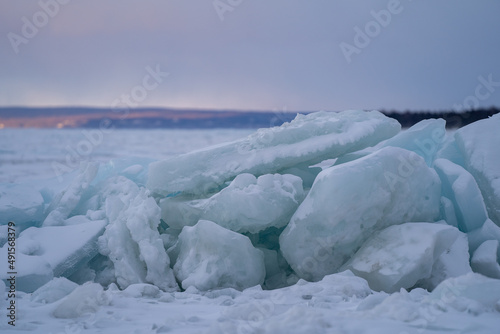 Blue Ice Chunks on Lake Michigan - Frozen Lake with Sunset, clouds, and mountains in the background