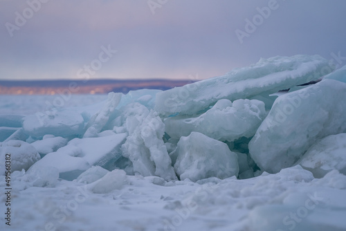 Blue Ice Chunks on Lake Michigan - Frozen Lake with Sunset, clouds, and mountains in the background