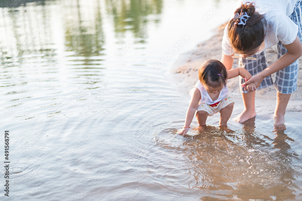 Fototapeta premium Portrait of happy loving mother and her baby outdoors.
