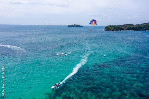 Tourists are playing parasailing game on Phu Quoc island, Vietnam photo