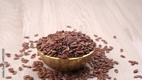 Brown flax seed or linseed on wooden background. Diet healthcare healthy food.