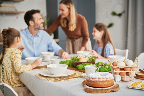 Caucasian family of four celebrating over easter table