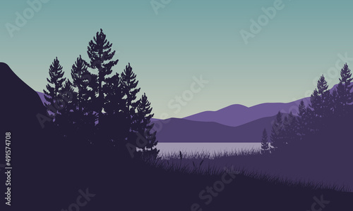 Great view from the lakeside with the silhouettes of pine trees all around