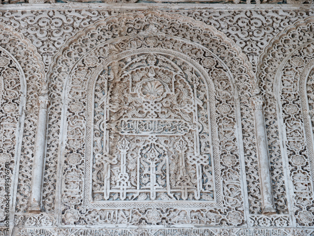 Close up detail of filigree walls, arches. Detailed handcraft of Moorish Architecture. Travel in time and discover history. Historic destination. Beautiful background and textures. 
