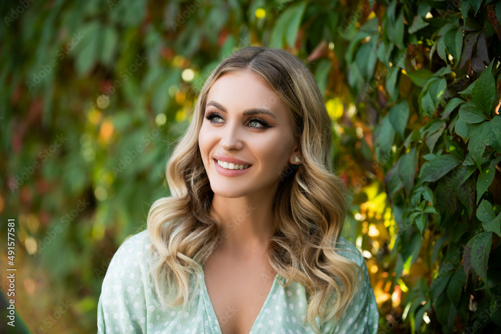 Portrait of young woman looking eways in summer park outdoor. Romantic girl with beauty face. Woman with romantic smile. Lifestyle, walk outdoors, enjoying life, positivity. Portrait of young woman looking eways in summer park outdoor. Romantic girl with beauty face. Woman with romantic smile. Lifestyle, walk outdoors, enjoying life, positivity.
