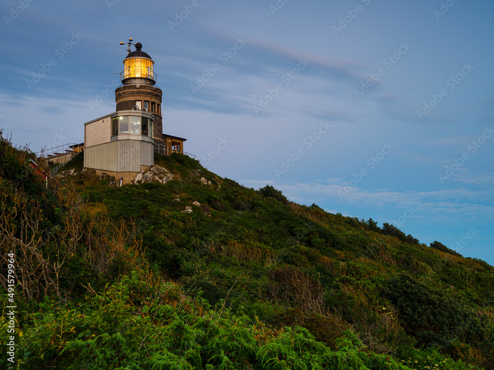 Old-fashioned lighthouse on hill Old-fashioned lighthouse on hill