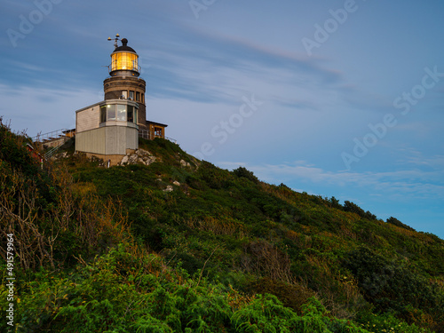 Old-fashioned lighthouse on hill