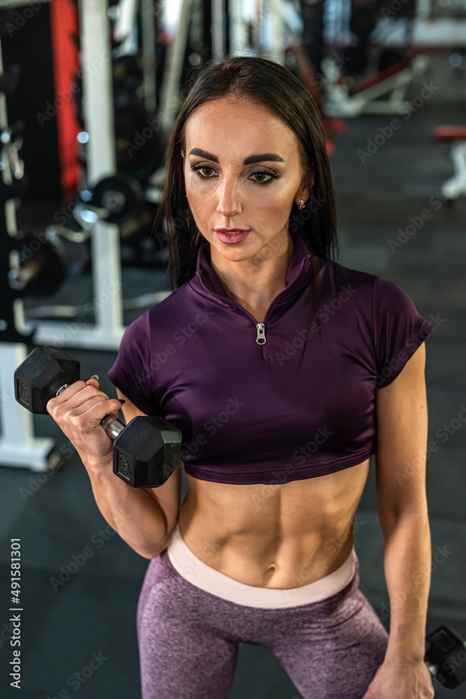 Fototapeta premium Young muscular caucasian woman doing exercise workout at the gym