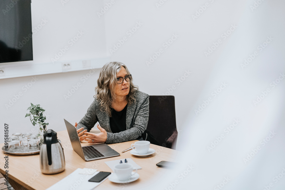 Woman sitting in office Woman sitting in office