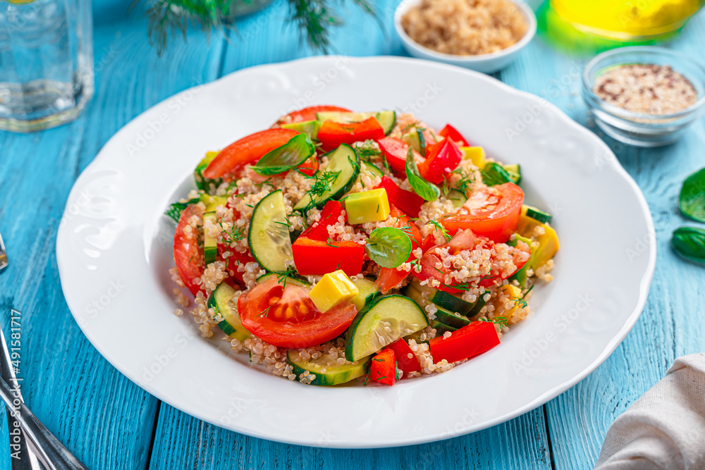 Tabbouleh salad with avocado and quinoa on a blue background.