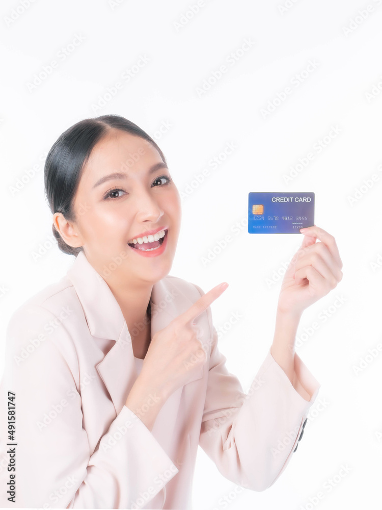 Business Asian woman showing and pointing credit card for payment shopping online isolated on white background , paying by credit card online shopping e-commerce telemarketing concept Business Asian woman showing and pointing credit card for payment shopping online isolated on white background , paying by credit card online shopping e-commerce telemarketing concept