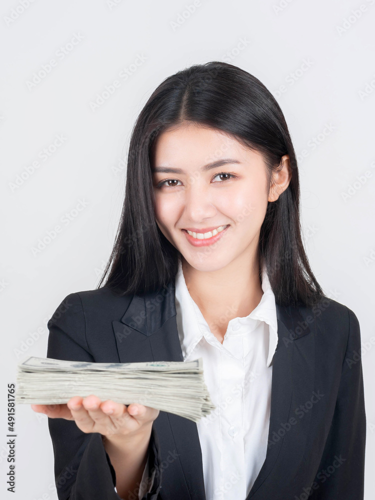 Successful beautiful Asian business young woman holding money US dollar bills in hand , business concept Successful beautiful Asian business young woman holding money US dollar bills in hand , business concept