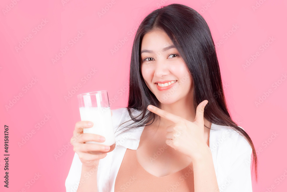 beautiful Asian woman cute girl feel happy drinking milk for good health in the morning on pink background - lifestyle beauty woman concept beautiful Asian woman cute girl feel happy drinking milk for good health in the morning on pink background - lifestyle beauty woman concept