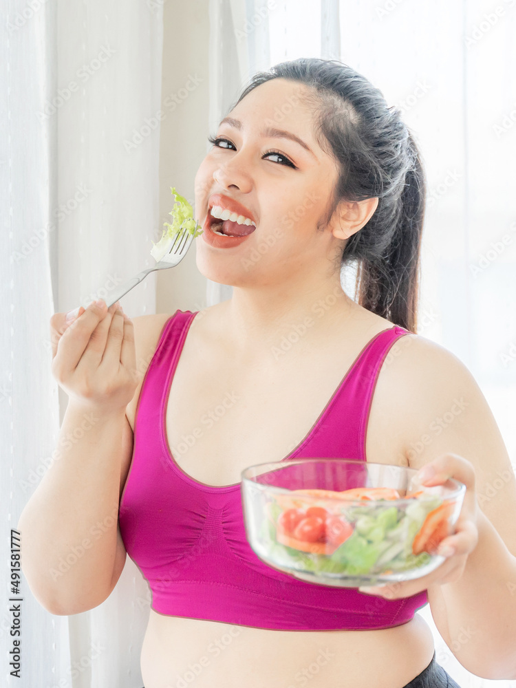Overweight asian plump female ,fat women , Fat girl , Chubby, eating vegetable salad - lifestyle Woman diet weight loss overweight problem concept Overweight asian plump female ,fat women , Fat girl , Chubby, eating vegetable salad - lifestyle Woman diet weight loss overweight problem concept
