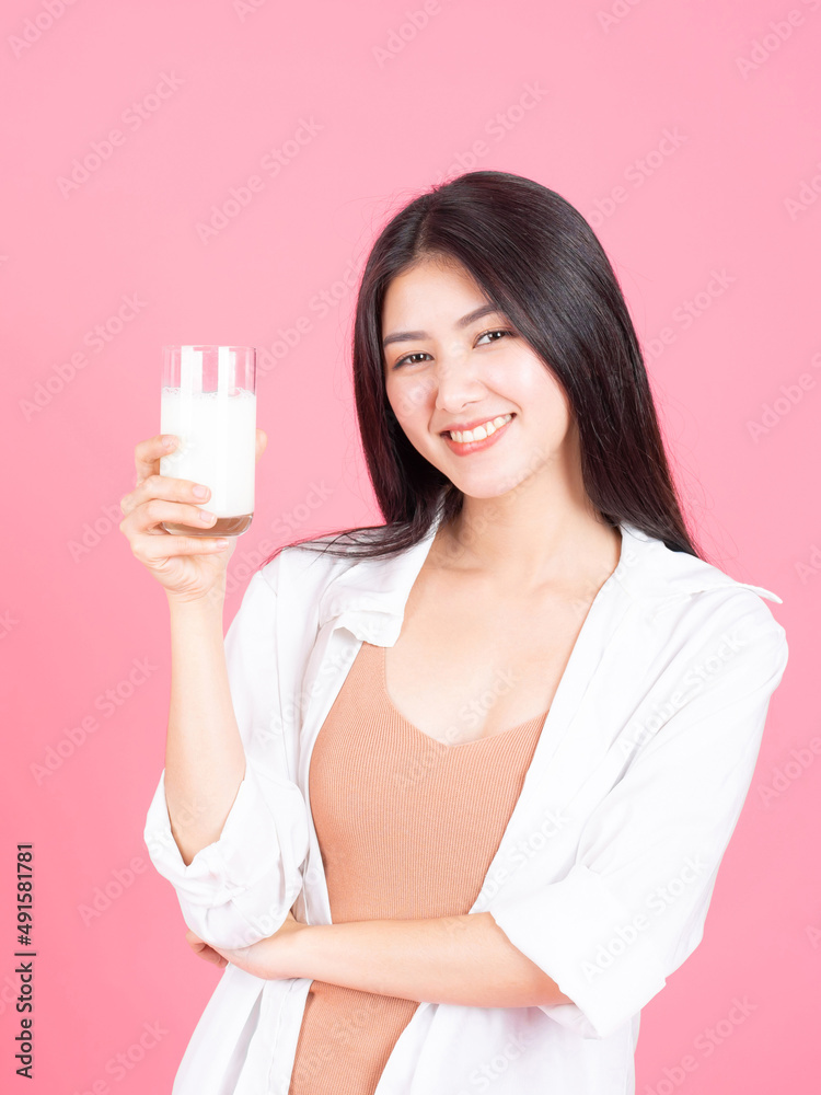 beauty woman Asian cute girl feel happy drinking milk for good health in the morning on pink background - lifestyle beauty woman beauty woman Asian cute girl feel happy drinking milk for good health in the morning on pink background - lifestyle beauty woman