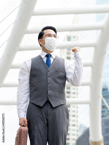 Portrait asian business man wearing protective face mask for protection during the quarantine Coronavirus covid 19 outbreak ,senior visionary executives leader with business vision