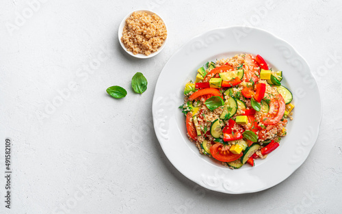 Vegetable salad with quinoa, dill basil on a gray background.