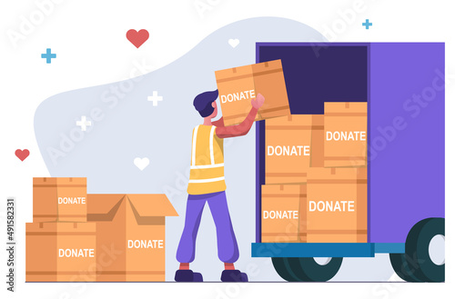 Humanitarian organization. Volunteer collects humanitarian aid, loads boxes into truck.