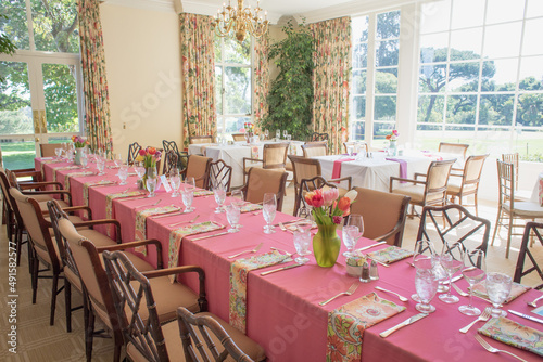 Long table with pink table cloth and flowers