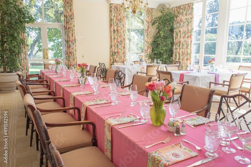 Long table with pink table cloth and flowers