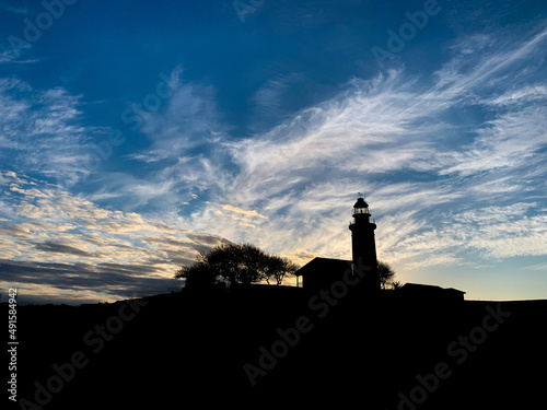 Lighthouse silhouette in the evening landscape 