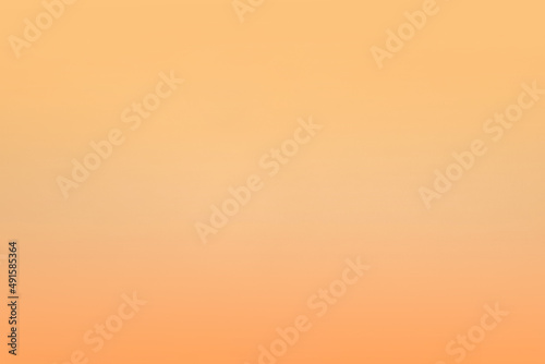 Blank soft plain pale light yellow color tone blend with orange peach gradation shade craft organic paper texture background for design on product packaging or website page