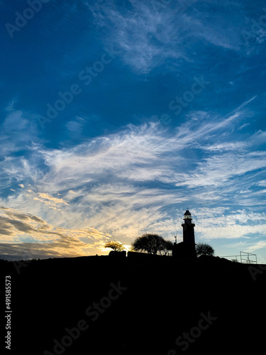 Lighthouse silhouette in the evening landscape 