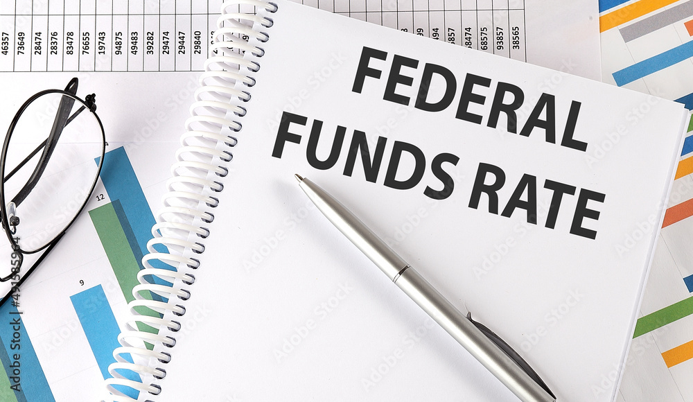 FEDERAL FUNDS RATE text , pen and glasses on the chart FEDERAL FUNDS RATE text , pen and glasses on the chart