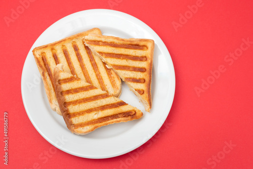 fresh breakfast toasts on white plate on yellow