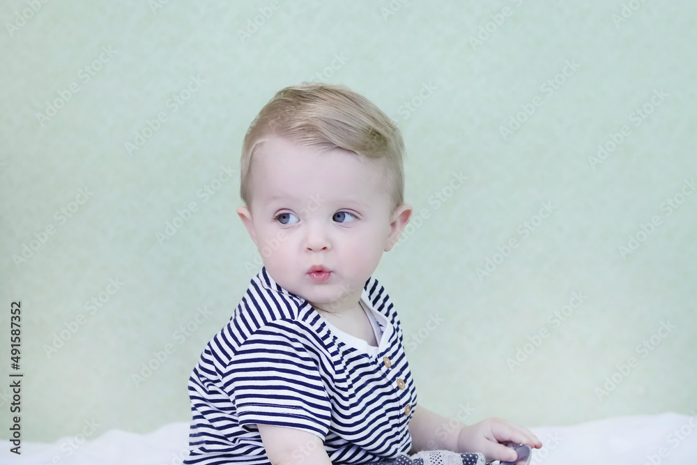 Defocused child opened his mouth and looks up in surprise. Background for sales. Copy space for your text - concept for baby products, shocking news, amazement, childhood Defocused child opened his mouth and looks up in surprise. Background for sales. Copy space for your text - concept for baby products, shocking news, amazement, childhood