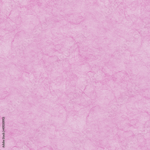 Pink paper texture. Rough surface with many vegetable fibers. Seamless background. 