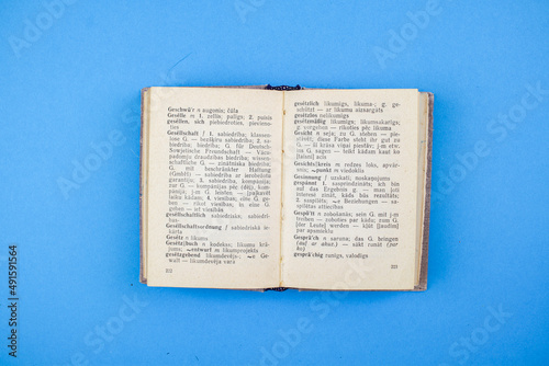 Old, Vintage Bible book on blue background