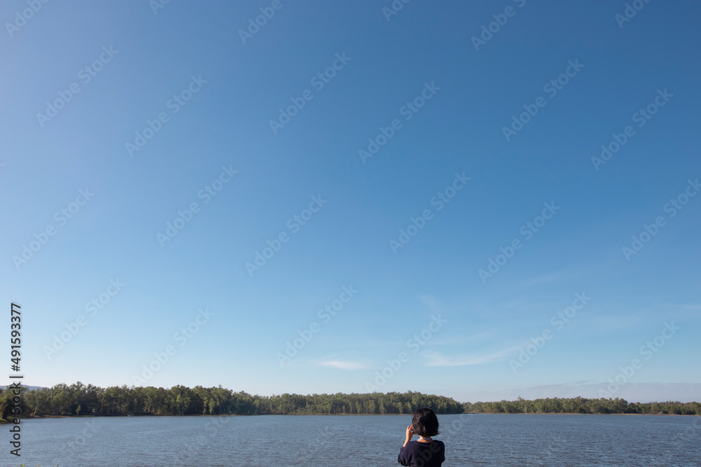 Woman taking a camera in .lake