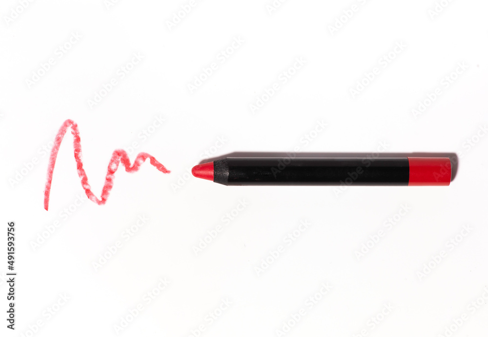 Red matte lipstick in the form of a pencil, smear texture on a white background Red matte lipstick in the form of a pencil, smear texture on a white background