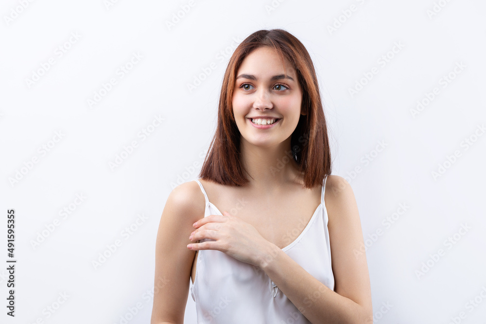 Beautiful smiling woman with clean skin, natural make-up and white teeth on a gray background Beautiful smiling woman with clean skin, natural make-up and white teeth on a gray background