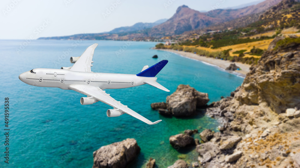 Airplane landing above beautiful beach and sea background Airplane landing above beautiful beach and sea background