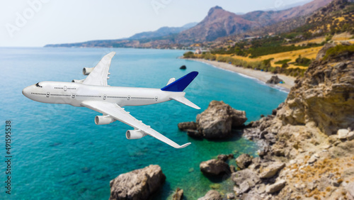 Airplane landing above beautiful beach and sea background