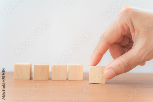 hand arranging group of wooden block on the table with white background for graphic resource element of banner design  concept