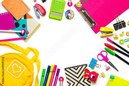 Back to school, education concept. Yellow backpack with school supplies - notebook, pens, ruler, calculator, scissors isolated on white background