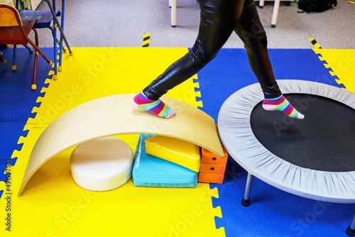 an autistic girl is treated in the form of a game by a psychologist, exercises on the ballancer help the brain, balance