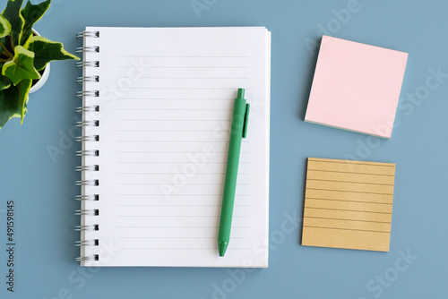 Blank note papers and pen on gray background, template, mock up, top view, flate lay