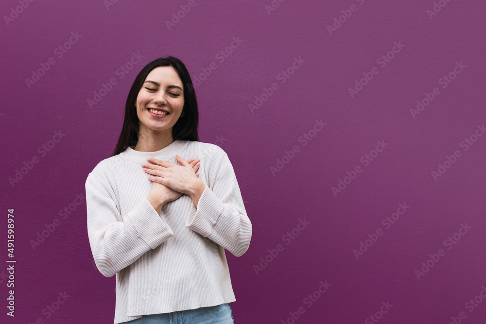 Portrait of happy nice looking asian woman hugs herself, expresses natural positive emotions Portrait of happy nice looking asian woman hugs herself, expresses natural positive emotions