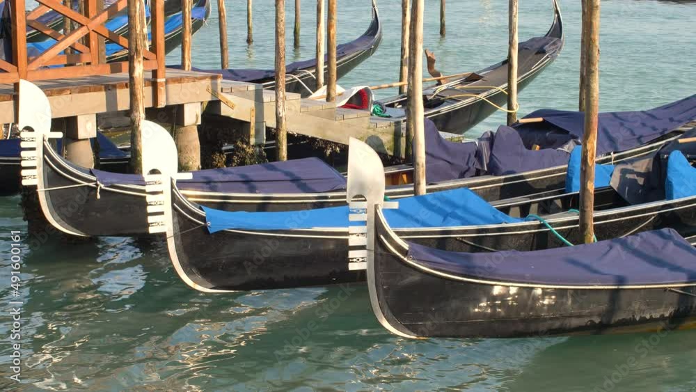 gondolas sway moored at the pier in piazza san marco in venice gondolas sway moored at the pier in piazza san marco in venice