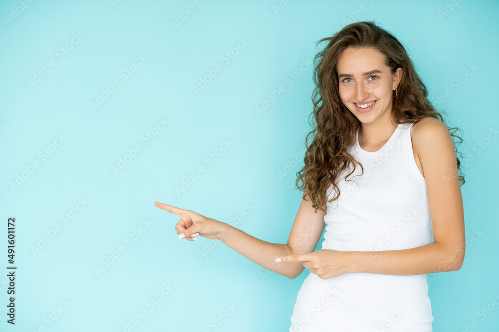 Invisible information. Happy woman. Sale promotion. Pretty elegant smiling lady holding hands up pointing fingers isolated blue copy space. Invisible information. Happy woman. Sale promotion. Pretty elegant smiling lady holding hands up pointing fingers isolated blue copy space.