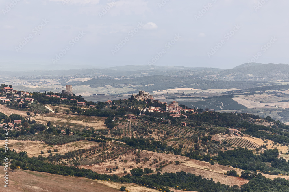 Panoramic view of the province of Tuscany with the city Castiglione d'Orcia on top of the hill and the tower Rocca di Tentennano. Val d'Orcia, Italy