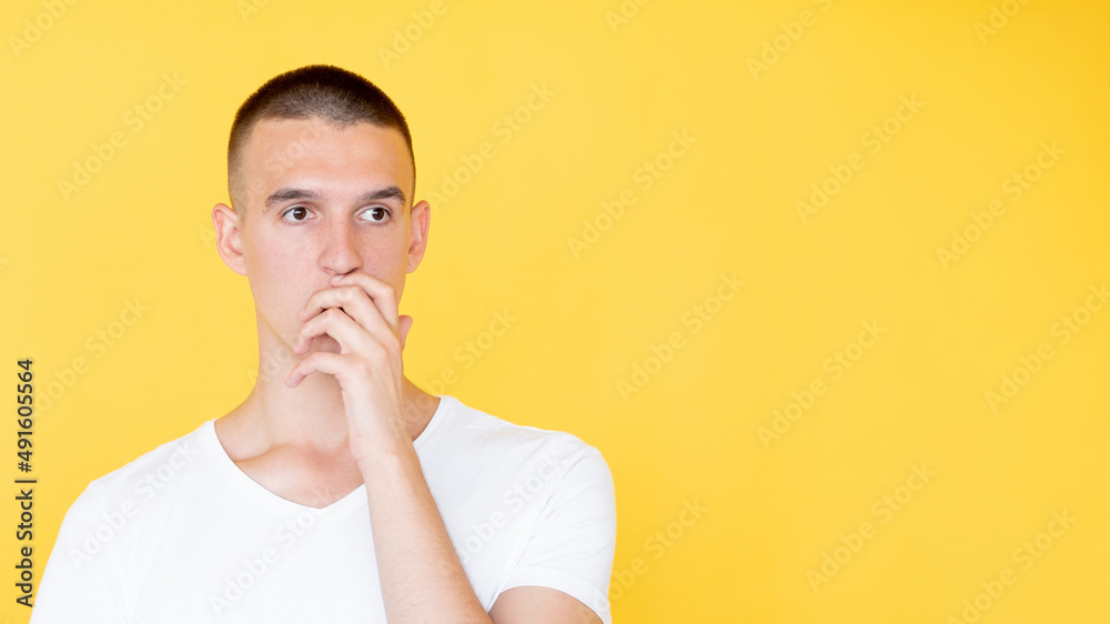 Unbelievable situation. Shocked man. Disbelief face. Attractive guy wide opened eyes covering mouth with hand isolated yellow copy space.