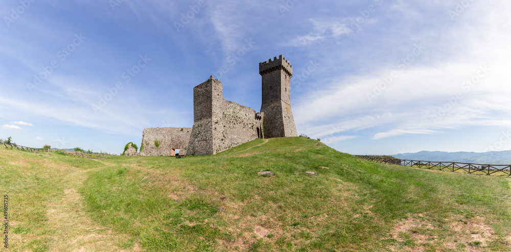 Wide panoramic view from beneath up to the Radicofani fortification construction, Tuscany, Italy